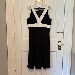 Sleeveless black dress with white trimmed bodice